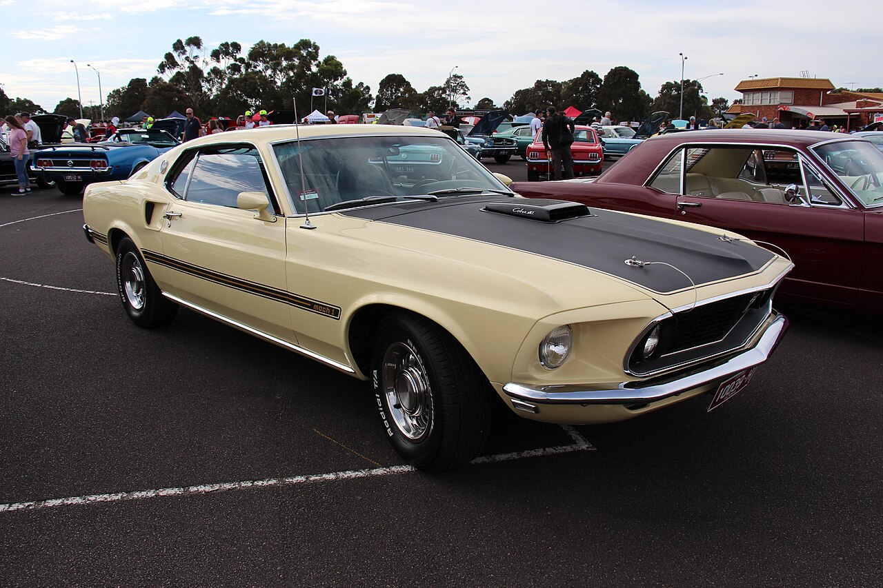 A Meadowlark Yellow 1969 Ford Mustang Mach 1 with 428 Cobra Jet power.