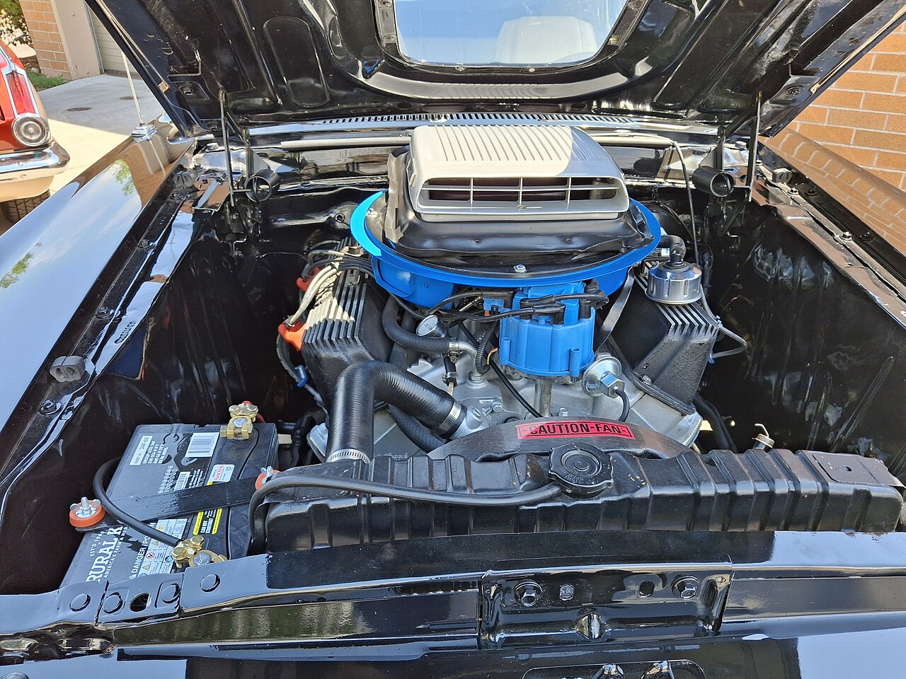 A 428 FE V8 in the engine bay of a 1969 Ford Mustang Mach 1. This is a photograph of an individual car, not a factory diagram.
